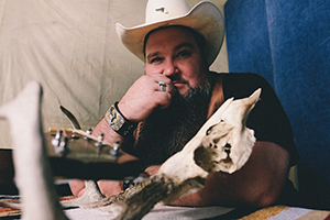 Sundance Head with Guitar and touching face