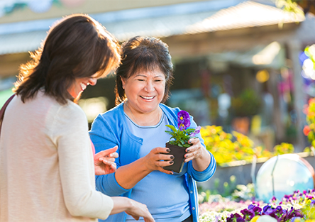 A hispanic mom and daughter picking out flowers