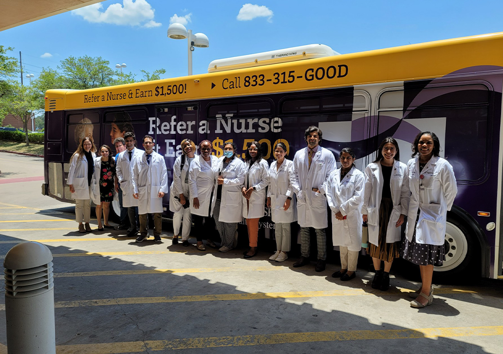 Residents standing outside a bus 