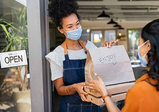 Two women wearing mask to help prevent COVID-19